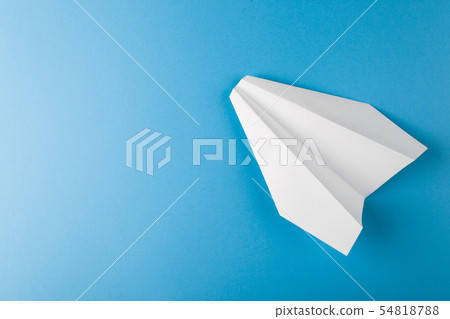 Flat lay of white paper plane and blank paper on pastel blue color background Flat lay of white paper plane and blank paper on pastel blue color background 54818788