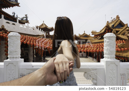 Young woman holding man hand leading travel 54819123