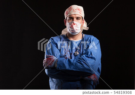 Man in doctor costume for halloween looking with a bizzare face at the camera 54819308