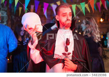 Handsome man dressed in a Dracula costume for halloween 54819398