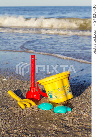 Children's toys on the beach. Spatula, rake 54820430