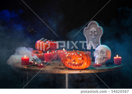 Orange pumpkin carved with scary face for halloween party on a wooden table 54820567