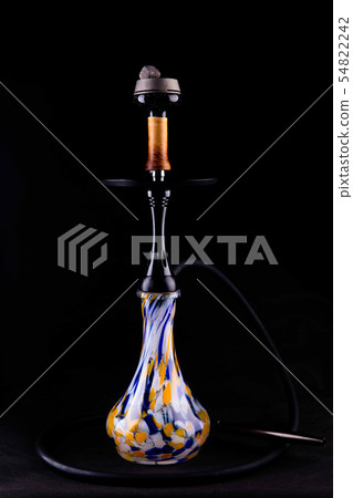 A hookah with a bowl from a whole tree with a glas 54822242