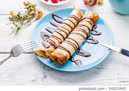 Twisted pancakes stuffed with chocolate 54822645