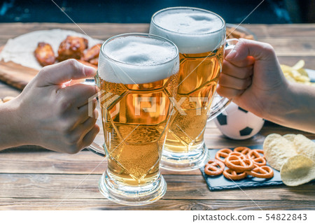 Appetizers and beer on the table for watch the football match. Appetizers and beer on the table for watch the football match. 54822843