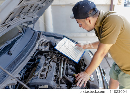 Mechanic technician man repair fixing car at home. 54823004
