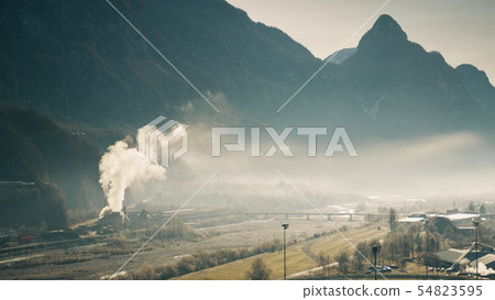 Air polluting facility in the river valley, northern Italy 54823595