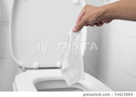 man throwing a wet wipe to the toilet man throwing a wet wipe to the toilet 54823669