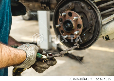Photo of repair of a running gear of the car hands Photo of repair of a running gear of the car hands 54825440