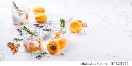 Natural yogurt with pieces of apricots and 54825951