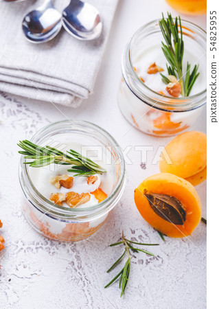 Natural yogurt with pieces of apricots and 54825955