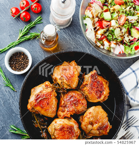 Delicious fried chicken thighs in a cast iron 54825967