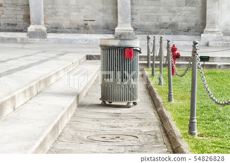 gray metal litter bin for garbage and waste in the city of Pisa in the Square of Miracles, near a gray metal litter bin for garbage and waste in the city of Pisa in the Square of Miracles, near a 54826828