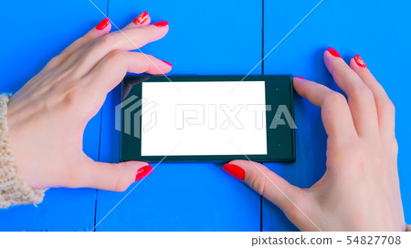 Woman looking at smartphone with white empty display Woman looking at smartphone with white empty display 54827708