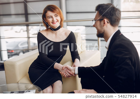 Stylish and elegant couple in a car salon 54827914
