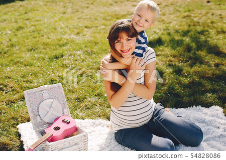 Mother with son playing in a summer park Mother with son playing in a summer park 54828086