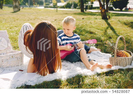 Mother with son playing in a summer park 54828087