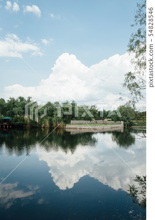 beautiful country house near the lake on a sunny day with clouds beautiful country house near the lake on a sunny day with clouds 54828546