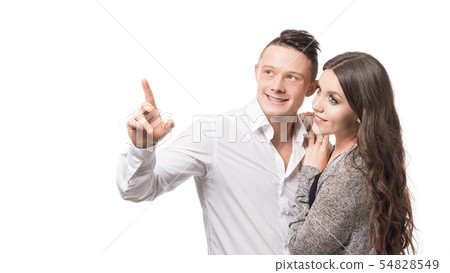 Man showing something to his beloved wife isolated on white background with copy space Man showing something to his beloved wife isolated on white background with copy space 54828549