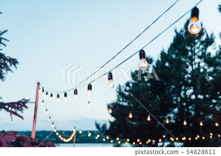 Light bulb decor in outdoor party, Wedding party Light bulb decor in outdoor party, Wedding party 54828611