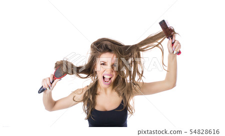 Young beautiful girl having problems while hair. Isolated studio shot Young beautiful girl having problems while hair. Isolated studio shot 54828616