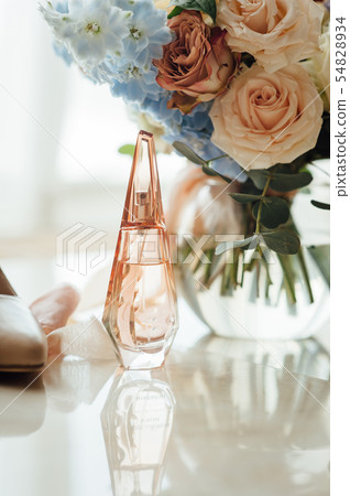 wedding set of the bride. Beige shoes, perfume and a beautiful bouquet 54828934
