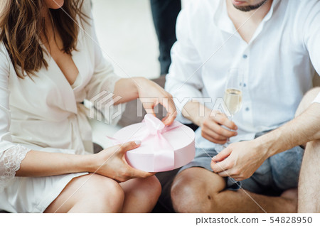 Portrait of beautiful happy couple man and woman are eating macaron biscuits Portrait of beautiful happy couple man and woman are eating macaron biscuits 54828950