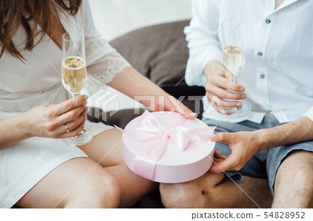 Portrait of beautiful happy couple man and woman are eating macaron biscuits Portrait of beautiful happy couple man and woman are eating macaron biscuits 54828952