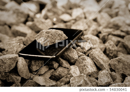 Cell phone on granite stones, unbreakable gadget Cell phone on granite stones, unbreakable gadget 54830041