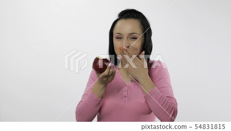 Young beautiful eating red apple. Healthy nutrition Young beautiful eating red apple. Healthy nutrition 54831815