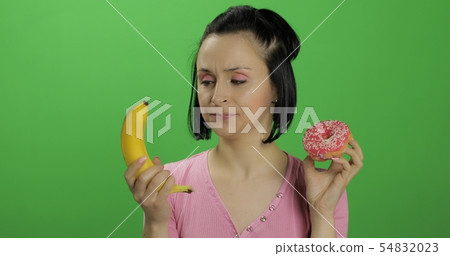 Starting healthy eating. Say no to junk food. Choice donut or banana to eat Starting healthy eating. Say no to junk food. Choice donut or banana to eat 54832023