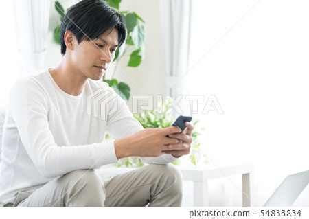 A man with a smartphone A man with a smartphone 54833834