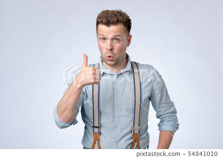 Young happy man showing thumbs up. Studio shot Young happy man showing thumbs up. Studio shot 54841010