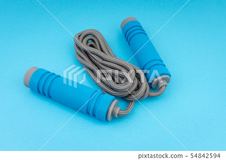 Skipping rope or jumping rope isolated on blue Skipping rope or jumping rope isolated on blue 54842594