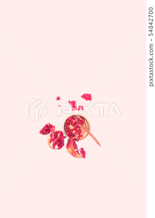 Pomegranate seeds on plate on black background Pomegranate seeds on plate on black background 54842700