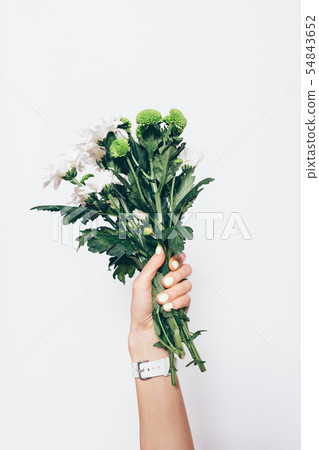 Female hand holding fresh green bouquet 54843652
