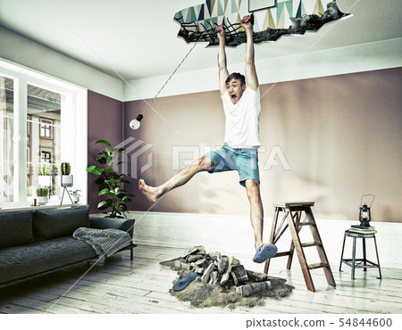 Broken Ceiling And A Man Hanging In The Hole Stock Photo