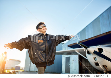 little boy plays near airfield, holding hands like airplane wings, dreams to be pilot little boy plays near airfield, holding hands like airplane wings, dreams to be pilot 54845301