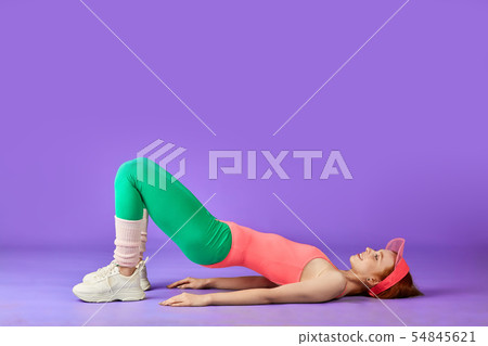 perfect-shaped ginger girl making hip bridge exercise 54845621