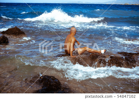 handsome man on the marine rocky shore handsome man on the marine rocky shore 54847102