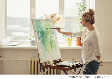 awesome woman applying paint on the paper awesome woman applying paint on the paper 54847327