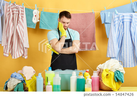 tired and desperate man standing behind the table with bowl and liquid. tired and desperate man standing behind the table with bowl and liquid. 54847426
