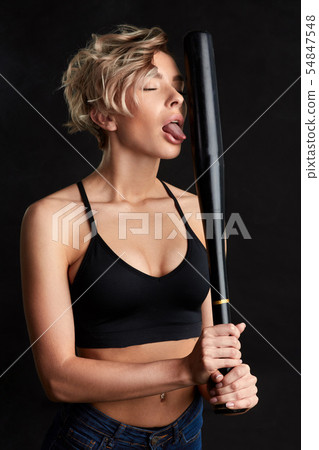 mad carzy girl hsowing her tongue while holding a bat mad carzy girl hsowing her tongue while holding a bat 54847548