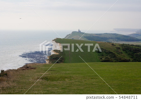 White chalk cliffs and Beachy Head Lighthouse. Eastbourne, East Sussex, England. Highest chalk sea White chalk cliffs and Beachy Head Lighthouse. Eastbourne, East Sussex, England. Highest chalk sea 54848711