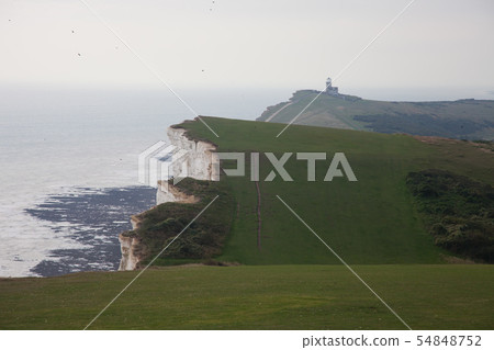 White chalk cliffs and Beachy Head Lighthouse. Eastbourne, East Sussex, England. Highest chalk sea 54848752