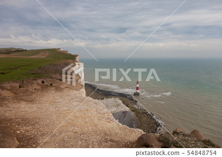 White chalk cliffs and Beachy Head Lighthouse. Eastbourne, East Sussex, England. Highest chalk sea White chalk cliffs and Beachy Head Lighthouse. Eastbourne, East Sussex, England. Highest chalk sea 54848754
