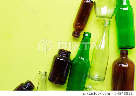 Glass bottles on green background. Glass bottles on green background. 54848851