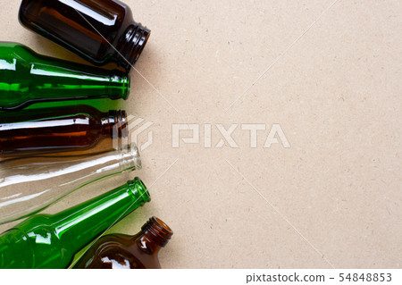 Glass bottles on wooden background. Glass bottles on wooden background. 54848853
