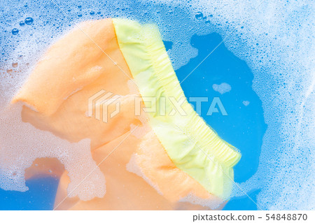 Yellow and orange baby shorts soak in water Yellow and orange baby shorts soak in water 54848870