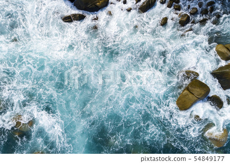 Aerial view of crashing waves on rocks landscape 54849177